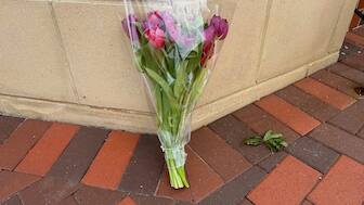 A lone bouquet sits outside a CVS pharmacy on Saturday, Aug. 9, 2025, near where police say a man was shooting at the headquarters of the U.S. Centers for Disease Control and Prevention in Atlanta. AP