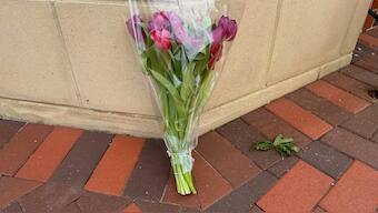 A lone bouquet sits outside a CVS pharmacy on Saturday, Aug. 9, 2025, near where police say a man was shooting at the headquarters of the U.S. Centers for Disease Control and Prevention in Atlanta. AP