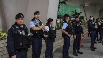 Police officers stand guard outside the West Kowloon Magistrates' Courts ahead of the closing statements for Hong Kong activist publisher Jimmy Lai's national security trial in Hong Kong. AP