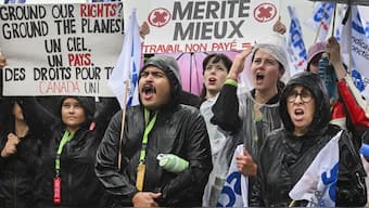 Air Canada employees and union members protest outside the Air Canada headquarters in Montreal, Sunday, Aug. 17, 2025, after the federal government intervened in the labour dispute between the airline and the union representing its flight attendants, ordering binding arbitration and operations to resume. AP