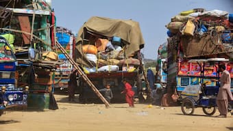 Afghan refugee children play next to trucks loaded with their family's belongings as they wait to return Afghanistan along a highway in Landi Kotal, Pakistan, on April 9, 2025. AP File