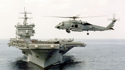 A US Navy SH-60 helicopter hovers off the bow of the USS Enterprise July 20, 1998, during a training exercise near Puerto Rico. The United States had deployed USS Enterprise and the 7th Fleet to intervene in the India-Pakistan War of 1971 on Pakistan's side. (Photo: Timothy Smith/US Navy/AFP) 