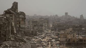 People walk down a street surrounded by buildings destroyed by Israeli bombardments in Gaza City, Gaza Strip, Tuesday, July 29, 2025. (Photo: Jehad Alshrafi/AP)