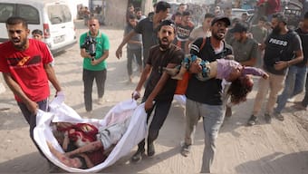 Palestinian men transport the bodies of children from the Irhim family, killed in an early morning Israeli strike on the Zaitun district, to Gaza City's Al-Shifa hospital on August 11, 2025. (Photo: Bashar Taleb/AFP)