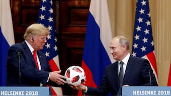 US President Donald Trump receives a football from Russian President Vladimir Putin as they hold a joint news conference after their meeting in Helsinki, Finland, July 16, 2018. (Photo: Grigory Dukor/Reuters)