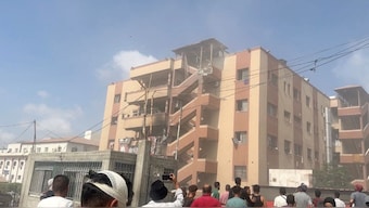 People walk at the site of Israeli strikes on Nasser hospital where journalists and civilians were killed, in Khan Younis in the southern Gaza Strip in this still image taken from video, August 25, 2025. Reuters