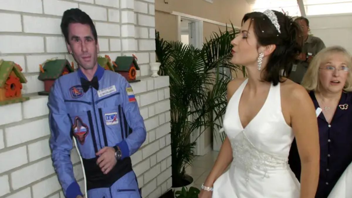 Ekaterina Dmitriev with a life-size cut-out of her new husband, Yuri Malenchenko, after her satellite wedding. File image/Reuters Ekaterina Dmitriev with a life-size cut-out of her new husband, Yuri Malenchenko, after her satellite wedding. File image/Reuters