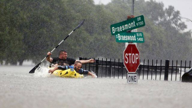 Two kayakers try to beat the current pushing them down an overflowing Brays Bayou from Tropical Storm Harvey in Houston, Texas. File image/AP