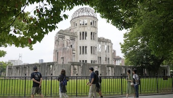 Tourists walk past the Atomic Bomb Dome on July 9, 2025 in Hiroshima, western Japan. AP