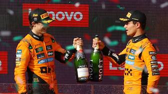 Lando Norris and Oscar Piastri celebrate on the podium after securing a McLaren one-two at the Hungarian Grand Prix. Reuters