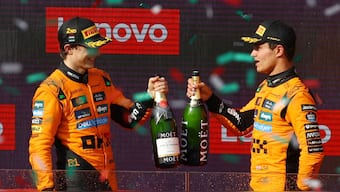 Lando Norris and Oscar Piastri celebrate on the podium after securing a McLaren one-two at the Hungarian Grand Prix. Reuters