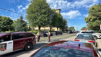 Law enforcement officers gather outside the Annunciation Church's school in response to a reported mass shooting, on Wednesday, in Minneapolis. AP