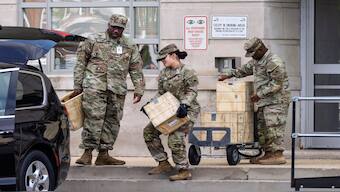 Troops load boxes of rifle ammunition at the District of Columbia National Guard Headquarters as President Donald Trump implements his order to use federal law enforcement and the National Guard to expel homeless people and rid the nation's capital of violent crime, in Washington, on Tuesday.  AP