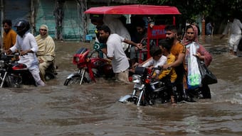Motorists ride through a flooded road caused by heavy monsoon rain in Lahore, Pakistan, Sunday, Aug. 3, 2025. (AP Photo)
