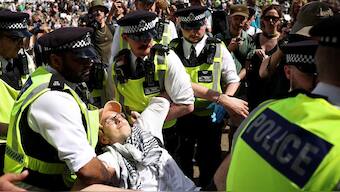 A protester is carried away by police officers at a "Lift The Ban" demonstration in support of the proscribed group Palestine Action, calling for the recently imposed ban to be lifted, in Parliament Square, central London, on August 9, 2025. 