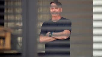 Brazil's former President Jair Bolsonaro stands at his home while under house arrest, ordered by Supreme Court Justice Alexandre de Moraes, as he awaits trial over an alleged plot to overturn the 2022 election, in Brasília, Brazil, August 14, 2025. REUTERS
