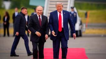 US President Donald Trump greets Russian President Vladimir Putin as he arrives at Joint Base Elmendorf-Richardson. AFP
