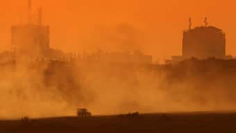 This picture taken from a position on the Israeli border with the Gaza Strip, shows Israeli troops deploying inside the besieged Palestinian territory on August 19, 2025. - AFP