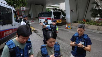 Police officers stand guard outside the West Kowloon Magistrates’ Courts building on the day of the closing submissions in the national security collusion trial of Jimmy Lai, founder of the now-defunct pro-democracy newspaper Apple Daily, in Hong Kong, China, August 18, 2025. REUTERS