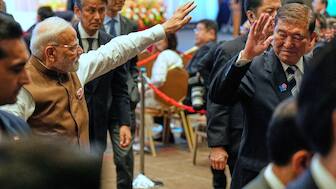 Indian Prime Minister Narendra Modi, left, and Japanese Prime Minister Shigeru Ishiba, right, wave as they leave the venue of the Japan India Economic Forum in Tokyo Friday, Aug. 29, 2025. (AP Photo)