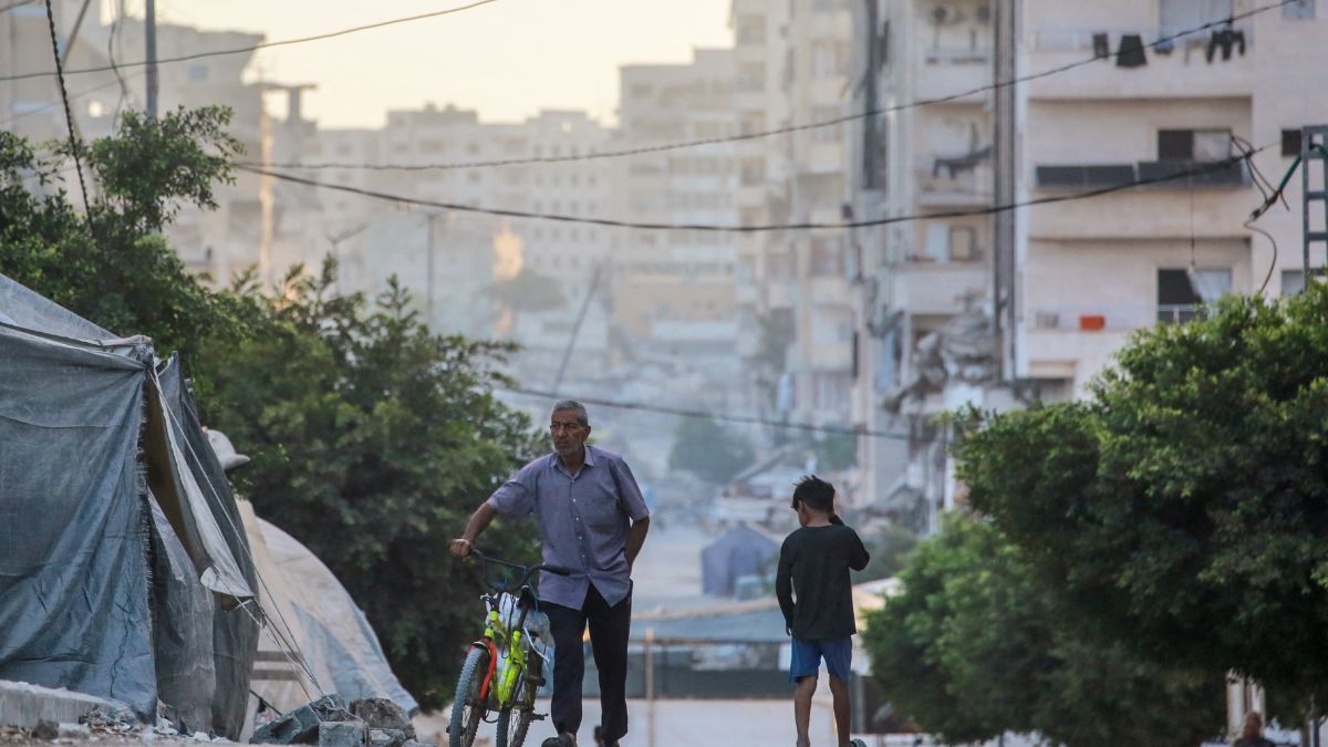 A man pushes a bicycle past a boy on a street in Gaza City on August 29, 2025, as the war between Israel and the Hamas terrorists movement continues. Image- AFP A man pushes a bicycle past a boy on a street in Gaza City on August 29, 2025, as the war between Israel and the Hamas terrorists movement continues. Image- AFP
