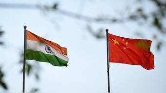 The national flags of India (L) and China are seen outside the Meijiang Meijiang Convention and Exhibition Center during the Shanghai Cooperation Organisation (SCO) Summit in Tianjin on August 31, 2025.- AFP