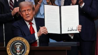 US President Donald Trump poses with the executive order to create a White House Olympics task force to handle security and other issues related to LA 2028 Summer Olympics. Image: Reuters