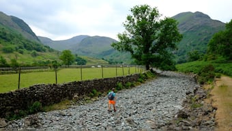A man walks along the dry river bed of the River Derwent after a prolonged period of dry weather in Seathwaite, UK, June 18, 2023. File Image/Reuters