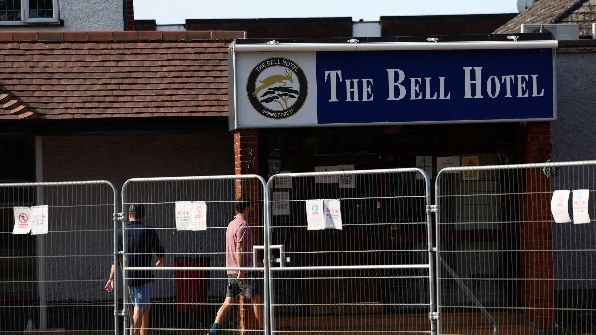 Men walk in The Bell Hotel, following Tuesday's High Court ruling in London that granted a temporary injunction to stop asylum seekers from being housed at the site, in Epping, UK, August 20, 2025. File Image/Reuters Men walk in The Bell Hotel, following Tuesday's High Court ruling in London that granted a temporary injunction to stop asylum seekers from being housed at the site, in Epping, UK, August 20, 2025. File Image/Reuters