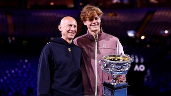Jannik Sinner poses with fitness coach Umberto Ferrara after winning the 2024 Australian Open in Melbourne. Reuters