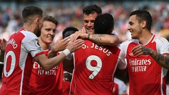 Arsenal players celebrate after scoring a goal. AFP