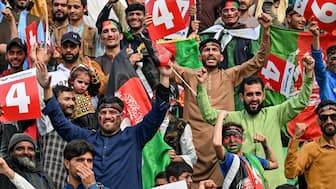 Afghanistan cricket fans cheer for their team during a match. AFP