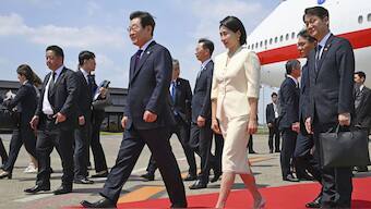 South Korean President Lee Jae Myung, center left, and his wife Kim Hea Kyung, center right, arrive at the Haneda airport in Tokyo, Japan, Saturday, Aug. 23, 2025. AP