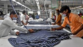 Garment workers cut fabric to make shirts at a textile factory of Texport Industries in Hindupur town in Andhra Pradesh, February 9, 2022. File Photo/Reuters