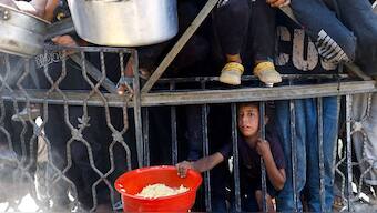 A Palestinian child waits to receive food from a charity kitchen after the global hunger monitor, Integrated Food Security Phase Classification (IPC), said that Gaza City and surrounding areas are officially suffering from famine that will likely spread, in Gaza City, August 28, 2025. Reuters