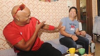 Vinod Kambli and Sachin Tendulkar share a light-hearted moment at the residence of their childhood coach, the late Ramakant Achrekar. AFP