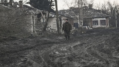A man walks on a muddy road in the Donbas region. The future of Ukraine’s industrial heartland in the east of the country is uncertain, after Vladimir Putin reportedly demanded it be handed to Russia. File image/AFP