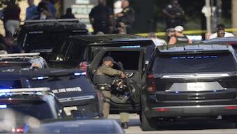 An armed Police officer prepares near the scene of shooting at the Emory University in Atlanta on Friday, Aug. 8, 2025. AP