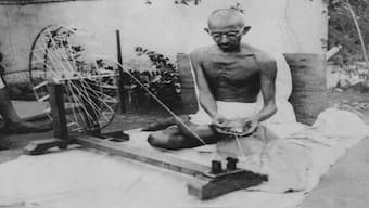 Mahatma Gandhi spinning khadi on a spinning wheel or charkha. Image Courtesy Wikimedia Commons