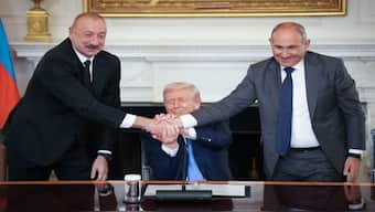 US President Donald Trump joins hands with Azerbaijani President Ilham Aliyev, left, and Armenian Prime Minister Nikol Pashinyan, right, during a ceremony signing and agreement to end the decades-long conflict between Armenia and Azerbaijani, in the State Dining Room of the White House on Friday. AFP