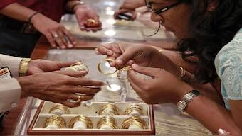 A customer looks at bangles before purchasing them at a gold showroom. There are concerns that Trump's tariffs on Swiss gold bars could impact the bullion trade around the world. Representational image/Reuters