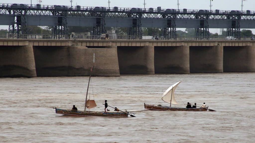 Fishermen ride their boats in the Indus River. AFP