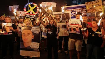 Demonstrators hold torches, during a protest outside Israeli Prime Minister Benjamin Netanyahu's office to demand the immediate release of the hostages kidnapped during the deadly October 7, 2023, attack on Israel by Hamas, and the end of the war, in Jerusalem. Reuters