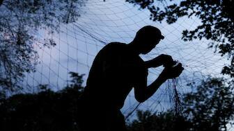 A service member of the 13th Operative Purpose Brigade 'Khartiia' of the National Guard of Ukraine installs an anti-drone net at a position in a front line, amid Russia's attack on Ukraine, in Kharkiv region, Ukraine. Reuters