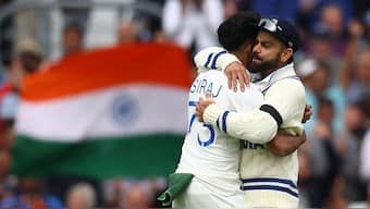 Mohammed SIraj hugs Virat Kohli after taking a wicket in Test against Australia. Reuters