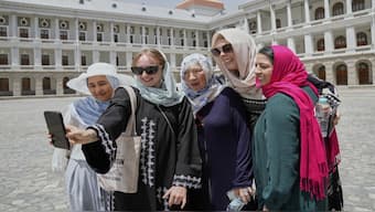 Zoe Stephens, 31, from Britain, takes a selfie with other foreign, female tourists at Darul Aman Palace in Kabul, Afghanistan. AP