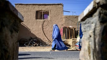 An Afghan burqa-clad woman walks along a street in Kandahar. File image/AFP
