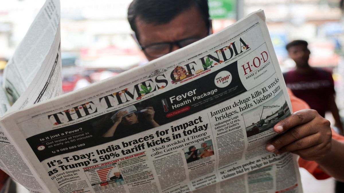 A man reads The Times of India newspaper, with the lead story on US tariffs on most Indian goods, in the old quarters of Delhi. File image/Reuters A man reads The Times of India newspaper, with the lead story on US tariffs on most Indian goods, in the old quarters of Delhi. File image/Reuters