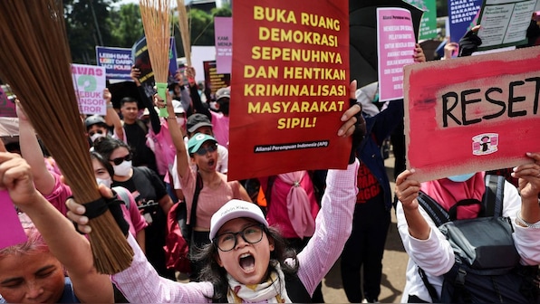 Indonesian women are carrying brooms to protests. Here’s why