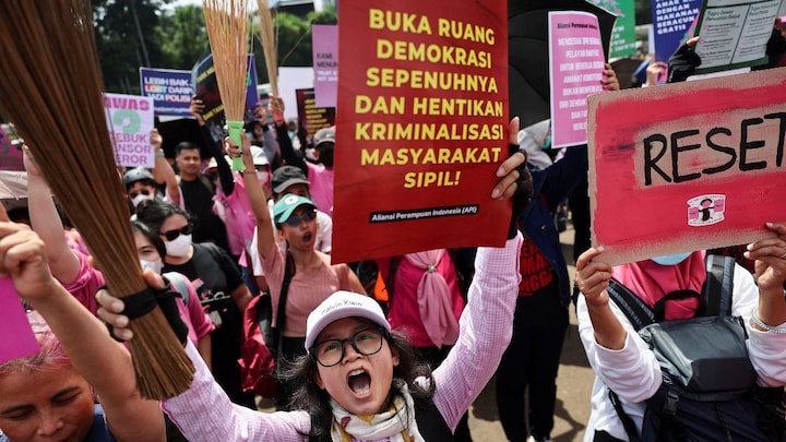 Indonesian women are carrying brooms to protests. Here’s why